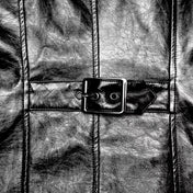 PVC polyester coat jacket trench trenchcoat jersey-knit fabric front zip zipper zippers studded studs shoulders buckle cuffs costume matrix cyberpunk futuristic goth gothic fashion bold glossy long-sleeve longsleeve long sleeve sleeved high-stand collar knee-length black