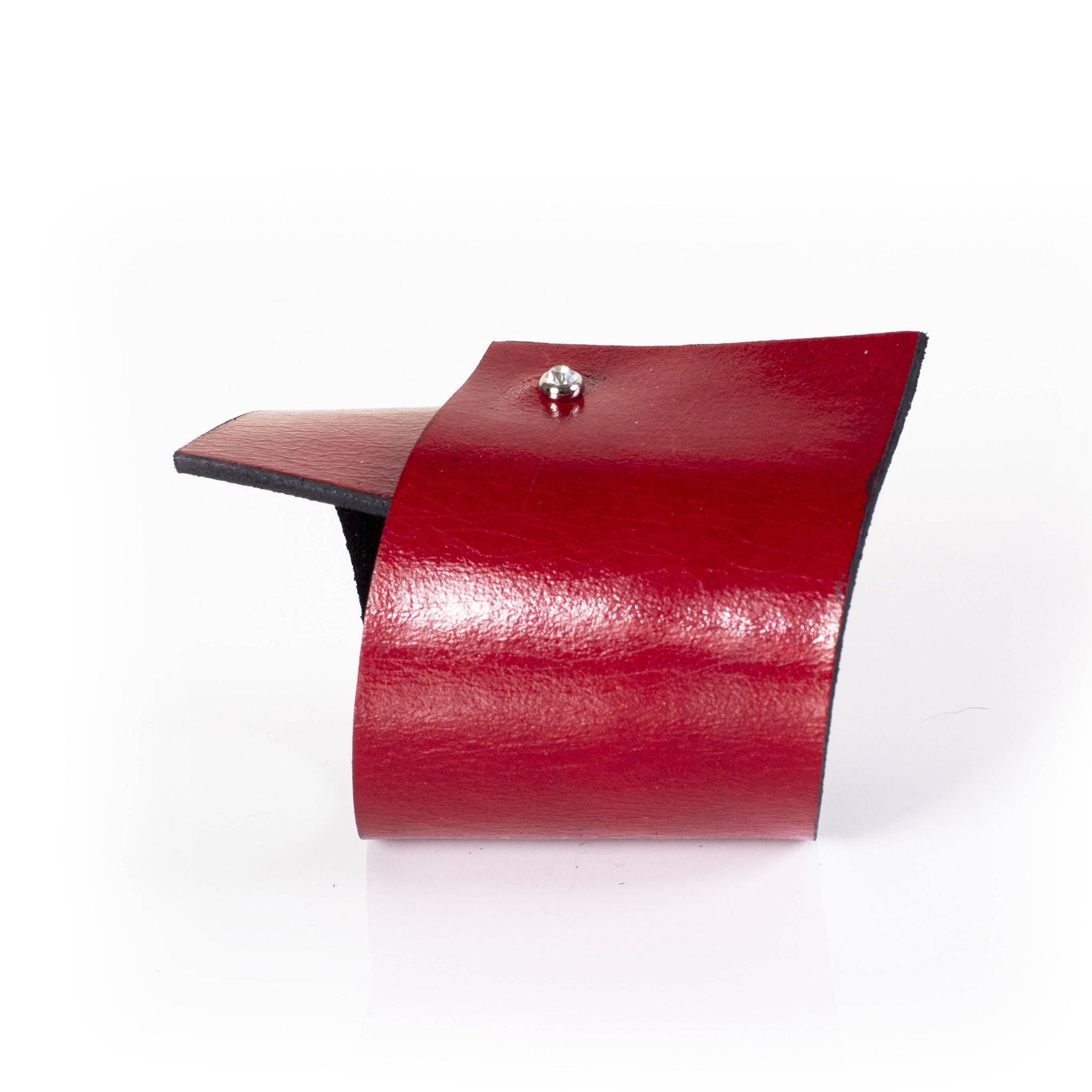 Premium leather wrist cuff bracelet asymmetrical rhinestone clasp punch-through unique angular modern fashion-forward artisinal handcrafted edgy arm gear accessories red