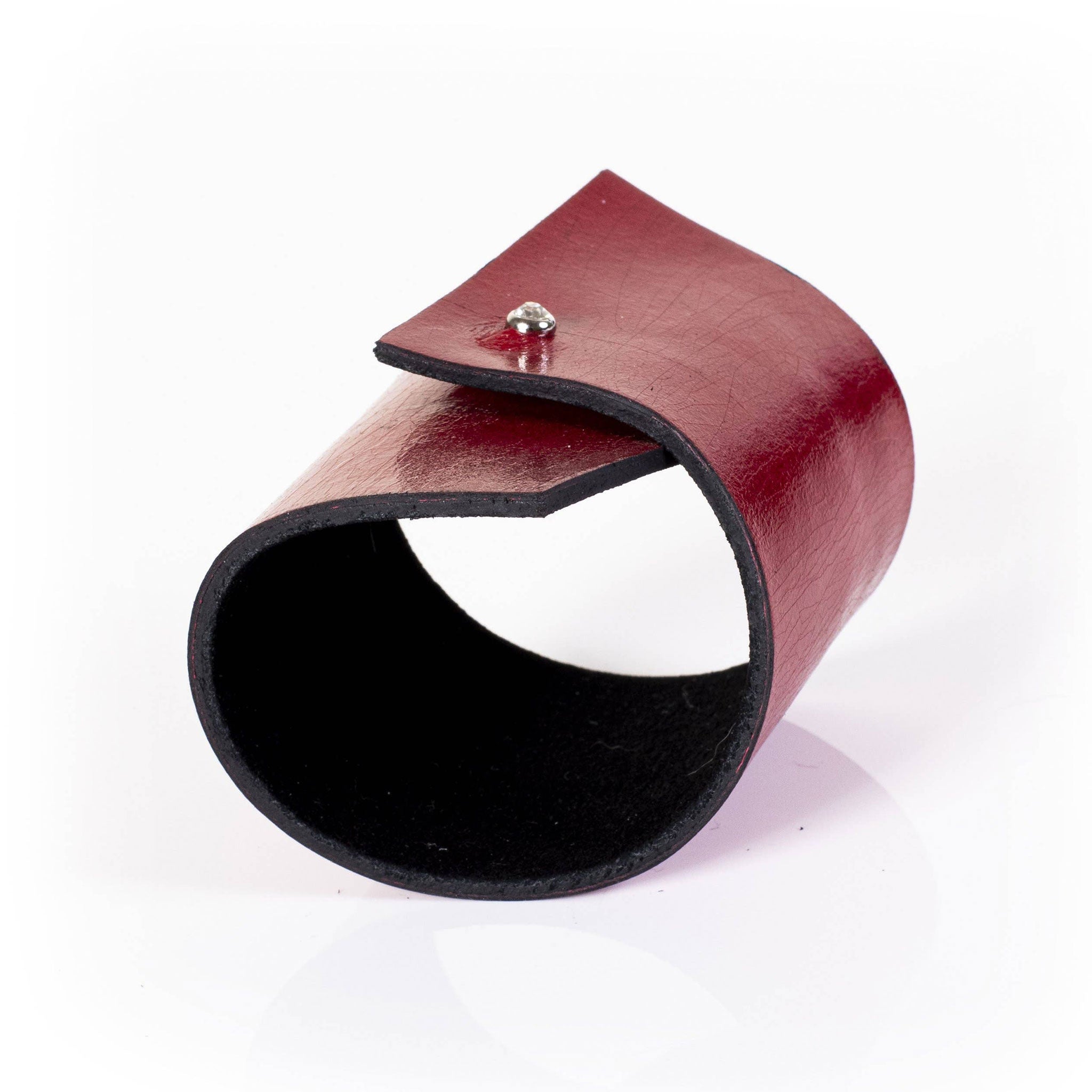 Premium leather wrist cuff bracelet asymmetrical rhinestone clasp punch-through unique angular modern fashion-forward artisinal handcrafted edgy arm gear accessories red