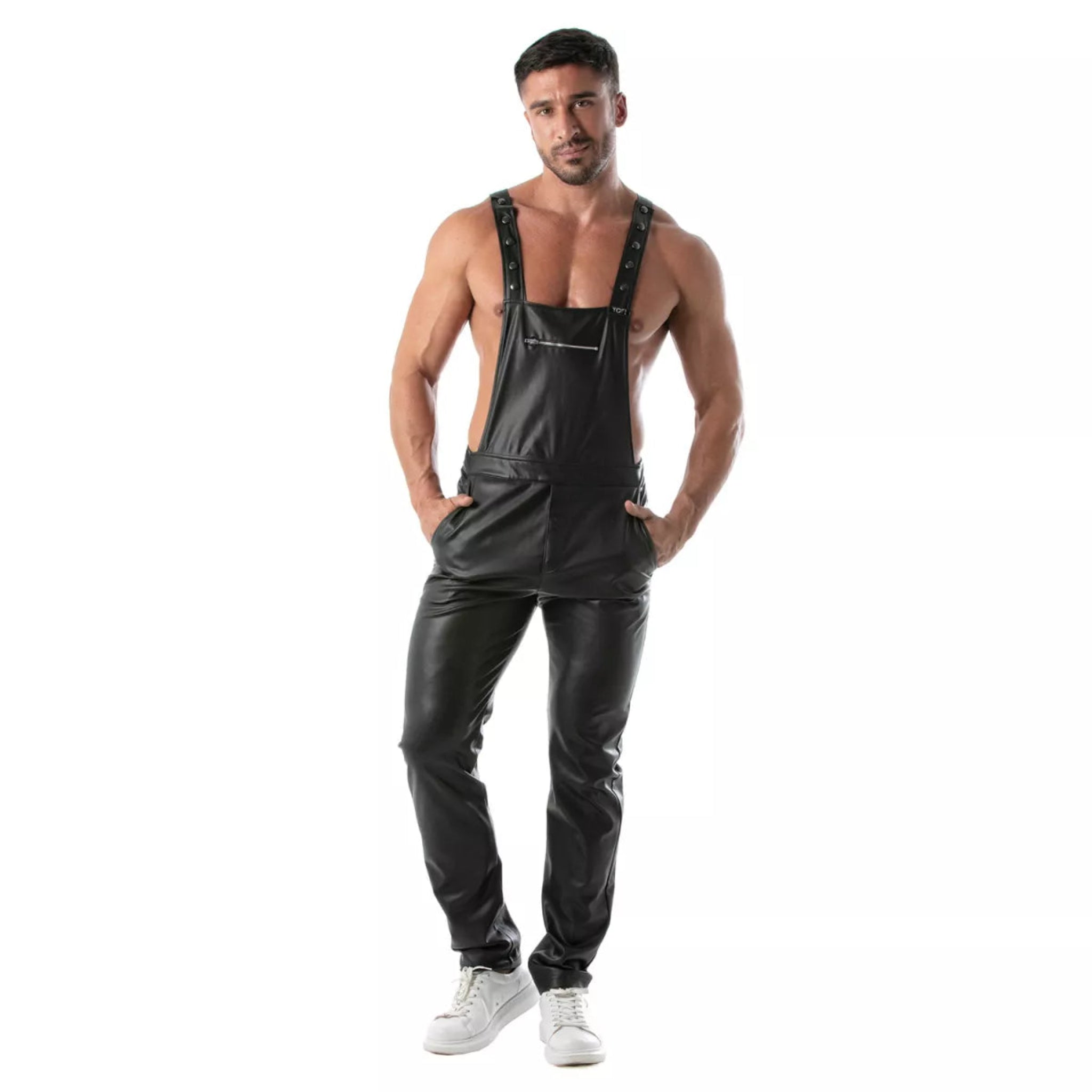 Black wetlook overall pants, fitted faux leather dungarees with adjustable straps, zippered chest pocket, and snap-button fly.