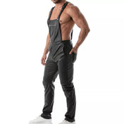 Black wetlook overall pants, fitted faux leather dungarees with adjustable straps, zippered chest pocket, and snap-button fly.