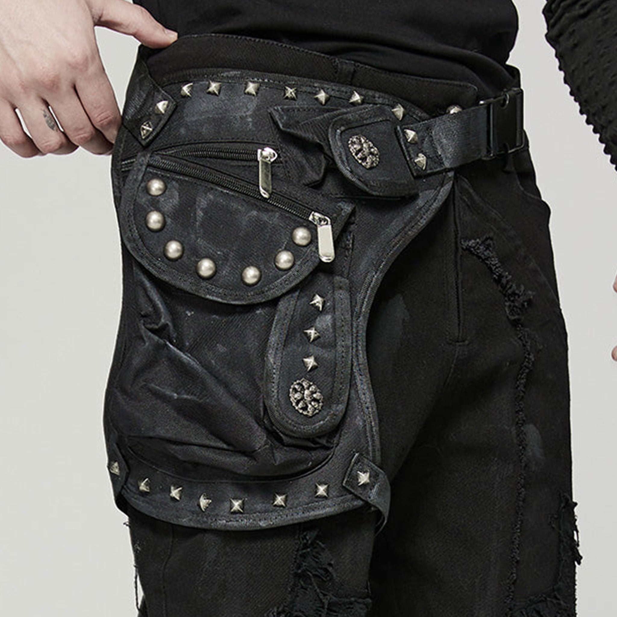 Polyamide twill nylon plastic bag leg-bag compact lightweight versatile ergonomic durable pockets external-pockets multi-functional multifunctional webbing safety-clip pyramid-stud dome-stud round-stud studded rivets zip zipper skull-detail bold unique alt-fashion fashion punk punk-inspired doomsday post-apocalyptic brush-detail costume cosplay halloween unisex black