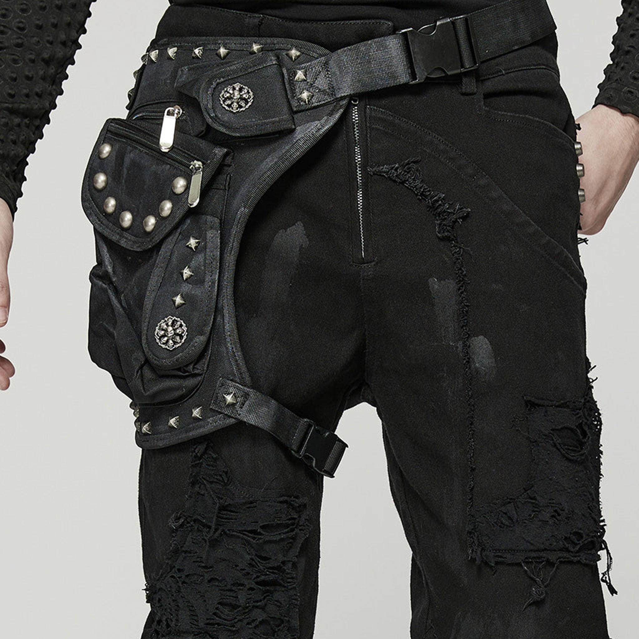 Polyamide twill nylon plastic bag leg-bag compact lightweight versatile ergonomic durable pockets external-pockets multi-functional multifunctional webbing safety-clip pyramid-stud dome-stud round-stud studded rivets zip zipper skull-detail bold unique alt-fashion fashion punk punk-inspired doomsday post-apocalyptic brush-detail costume cosplay halloween unisex black