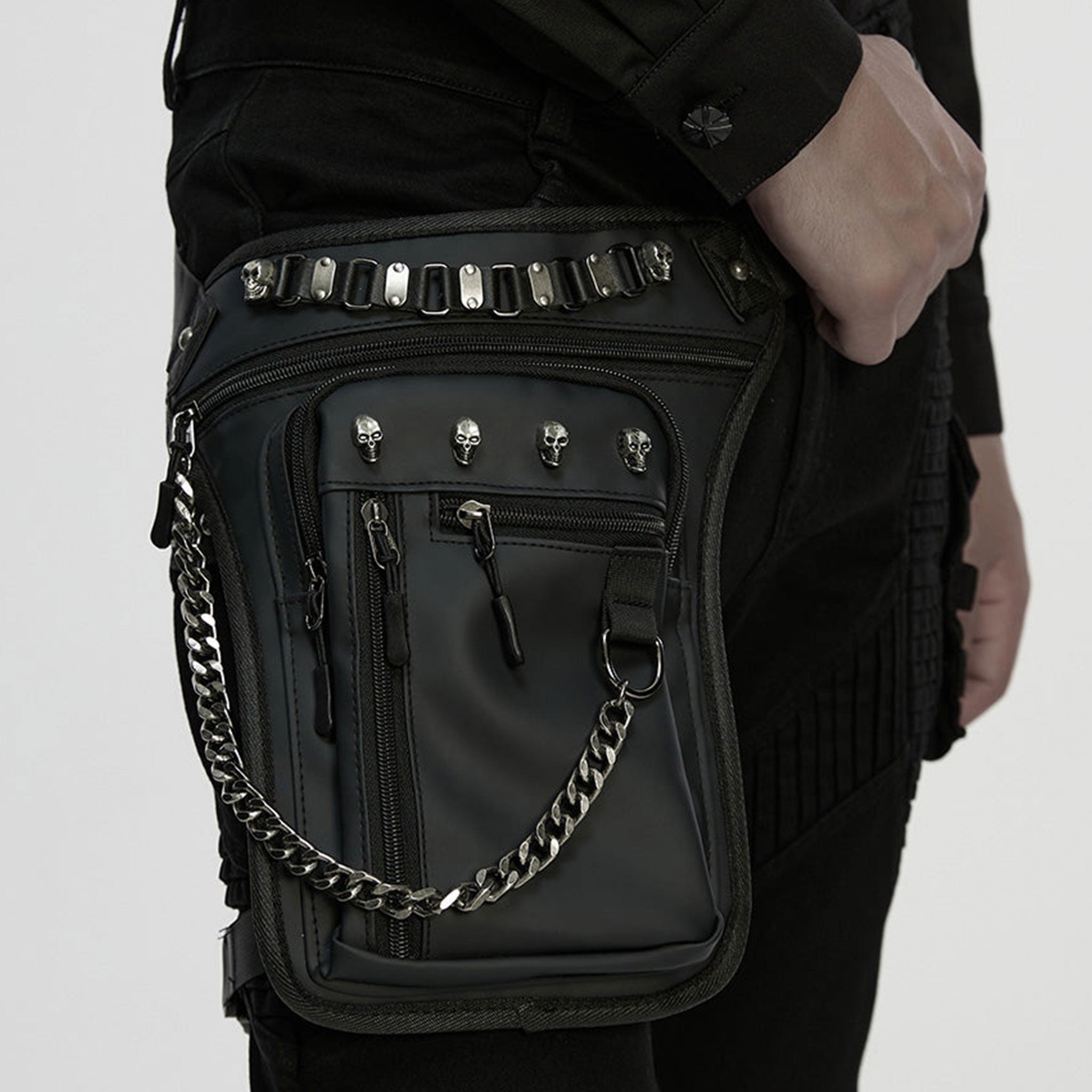 PU polyurethane nylon-webbing accessories bag fanny-pack thigh-bag thigh-holster variable versatile pockets pouches pouch compartments roomy safety-buckle adjustable chain-zip zipper zipper-compartments pull-tabs textured thigh-strap skull skeleton skeletal skull-accent fetish fashion alt-fashion punk edgy attitude practical bold rebellious dark style stylish urban striking costume cosplay halloween unisex black