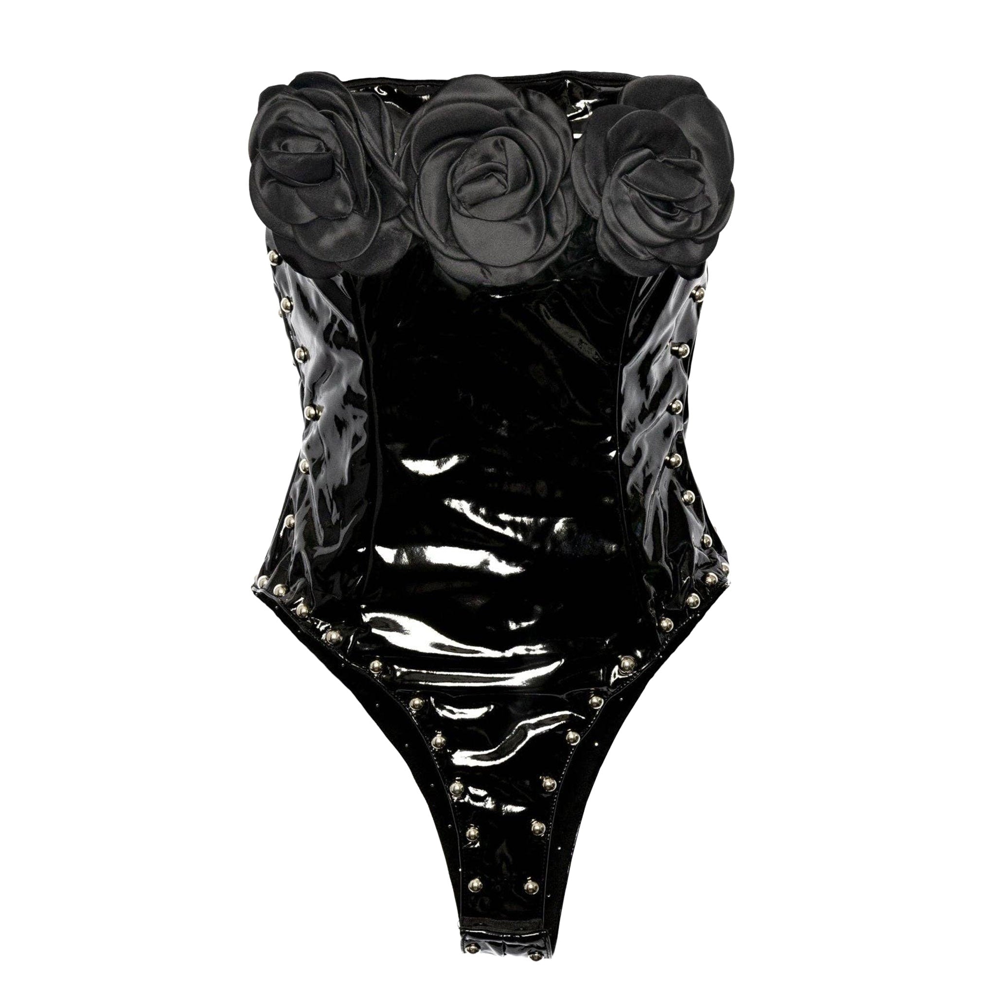 PVC vinyl polyester PU faux-leather patent-leather apparel tops one-piece onesie bodysuit sleeveless strapless cleavage roses big-roses studs studded dome-studs zipper back-zip hidden-zip half-zip high-leg snap-crotch snap-button shiny glossy unique edgy fetish fashion alt-fashion alternative punk goth gothic goth-doll rock pop-star costume cosplay halloween halloween-costumes female femme feminine womens black