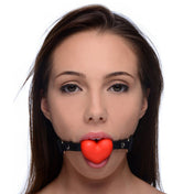 Silicone non-porous phthalate-free leather PU-leather accessories gag mouth-gag heart-shaped adjustable buckle soft playful odorless tasteless sexy fetish fashion alt-fashion alternative bedroom dungeon bondage bdsm bdsm-toys kink kinky kinky-play frisky heartbeat heart-beat sub submissive restraints muffled-sound stifled-speech valentines valentines-collection be-mine couples couples-play partnered-play adult-toys unisex red