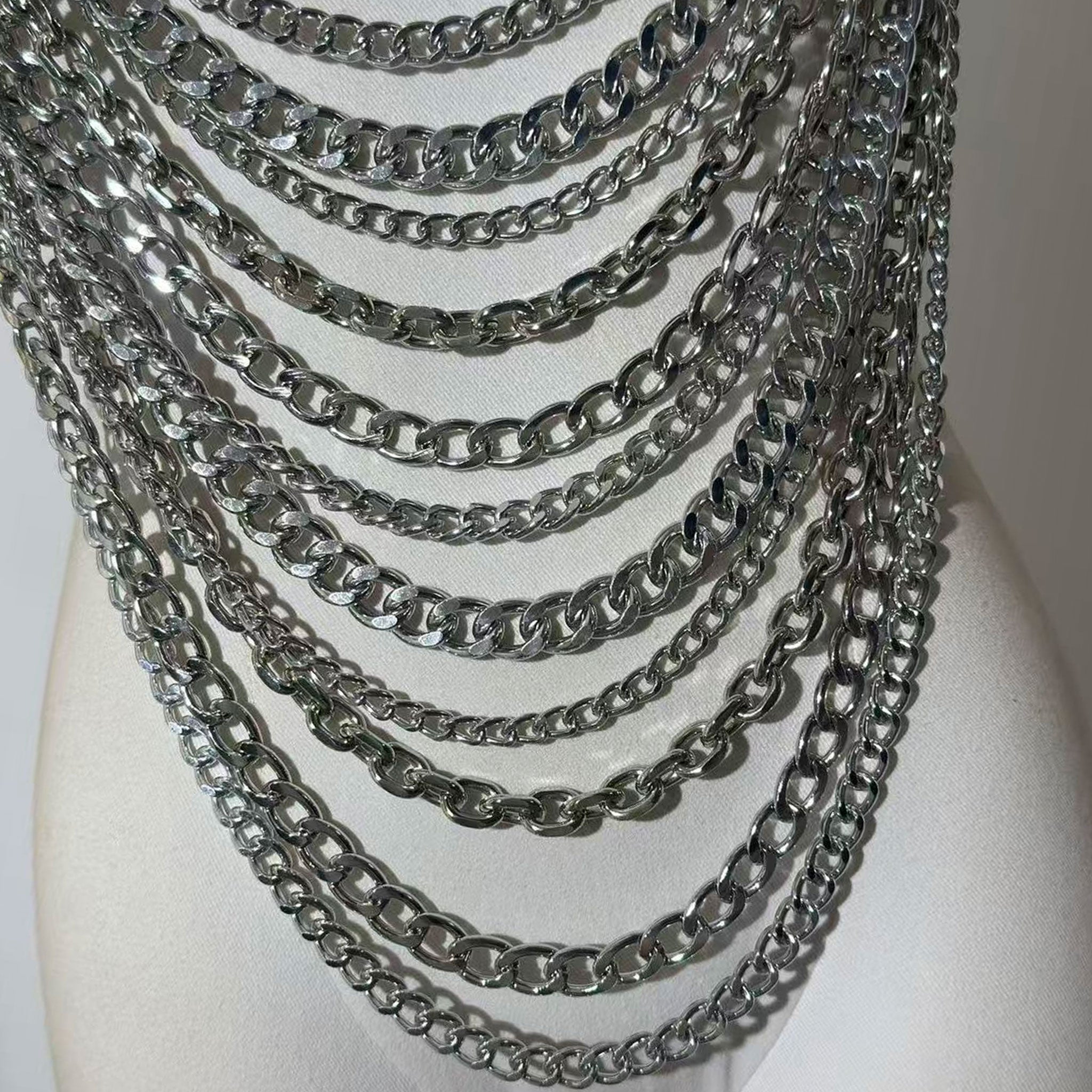 Metallic-chain cuban-link chainmail chain-mail mixed-chain hanging-chain draped-chain cable-chain apparel tops halter-top haltertop halter-dress croptop crop-top sleeveless adjustable lobster-clasp visual-movement edgy avant-garde fluid shiny sparkling bold architectural striking fetish fashion alt-fashion punk goth cyber gothic clubwear festivalwear costume cosplay halloween female femme feminine womens silver