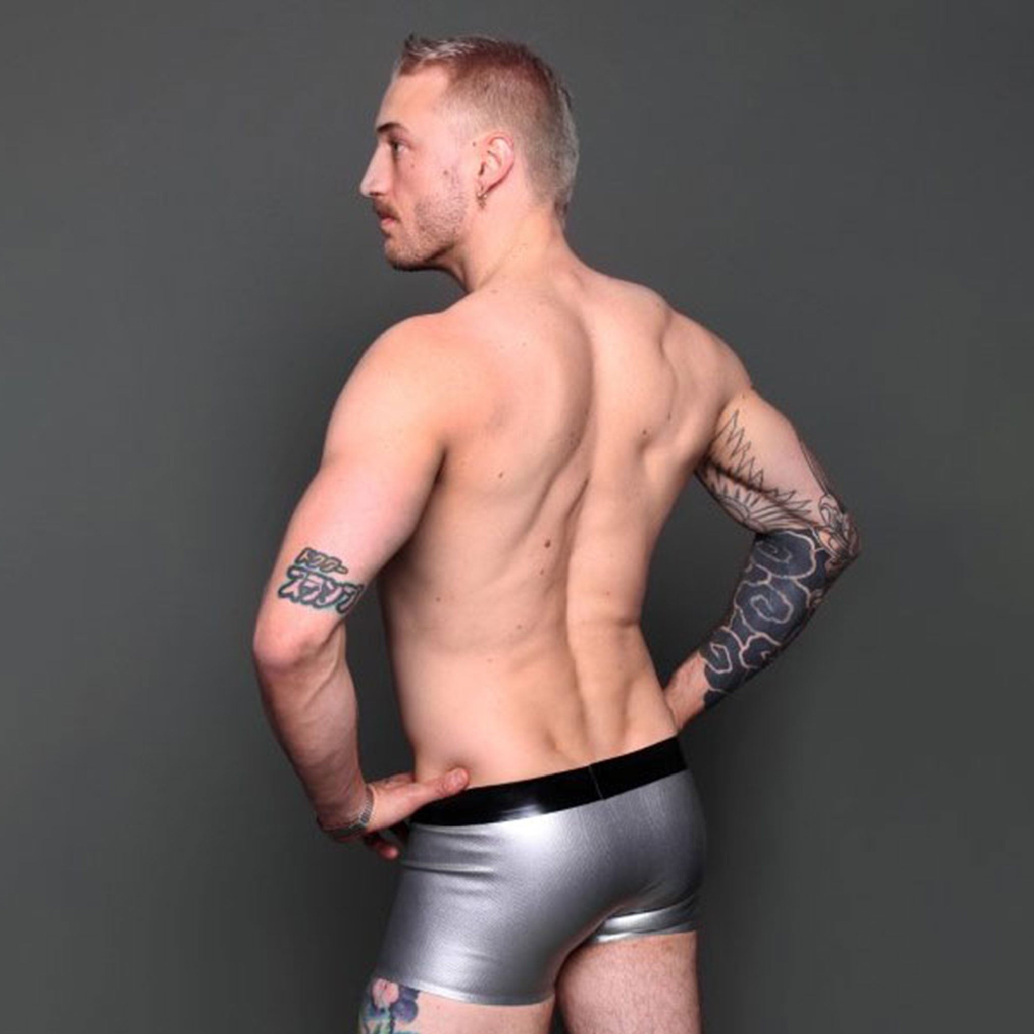 Latex rubber apparel bottoms shorts underwear etched-pattern snake reptile snakeskin textured scaly front-pouch crotch-pouch low-rise waistband two-tone contrast snug-fit comfortable sexy shiny slippery sleek fetish fashion alt-fashion clubwear bondage bdsm kink kinky kinkwear sensory sensual tactile male masculine masc mens menswear guys dudes black silver metallic