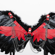 Feather wings harness black and red, sexy harness with chains and feathers, gothic angel wings costume accessory, feathered wings harness for festivals, black and red feather wings with chain details.