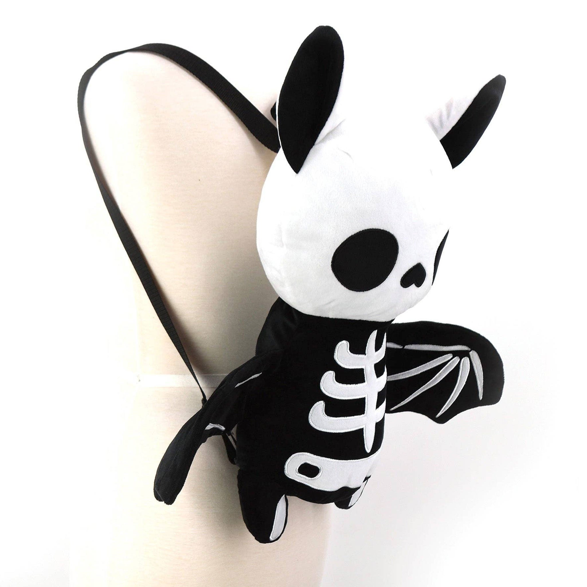 Polyester plush nylon plastic accessories bag backpack novelty-backpack stuffed-animal bat zipper back-zip fabric-lining single-compartment adjustable shoulder-strap top-handle soft durable lightweight cute spooky quirky unique playful whimsical fashion alt-fashion alternative punk goth gothic kawaii kowaii harajuku emo dark-fashion everyday costume cosplay halloween halloween-inspired halloween-accessories skeleton skeletal holiday-shop gifts unisex black-white 