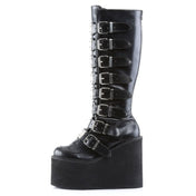 Leather vegan-leather textile-midsole synthetic-outsole accessories footwear shoes boots gogo-boots platform-heel wedge-platform platform-boots knee-high knee-hi metal-plate buckle-detail zipper full-zip back-zip adjustable buckle towering bold shiny glossy edgy fetish fashion alt-fashion alternative goth gothic goth-doll punk cyber cyberpunk ravewear raver-babe festivalwear clubwear costume cosplay halloween female femme feminine womens black